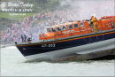 Crowds watch as the boat reaches the water