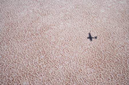 Shadow of Plane on Lake Eyre Salt Lake (15m below sea level), Lake Eyre National Park, Outback, South Australia, Australia - aerial 