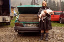 Woman selling pigs from the boot of her car at the market, Ocna Sugatag, Maramures, Romania