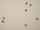Aerial View of Groups of People (close up). Rusty screws installation on the wall.