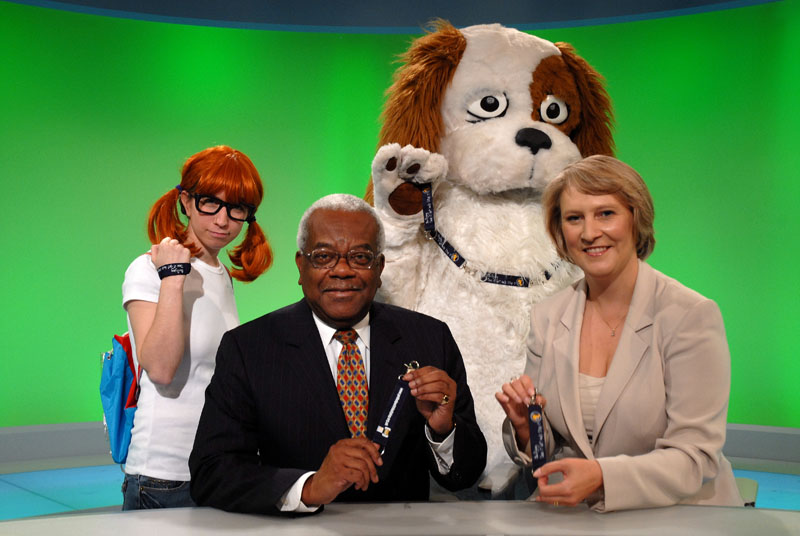 Sir Trevor McDonald with Sharon Doughty and characters from children's charity Kids Taskforce
